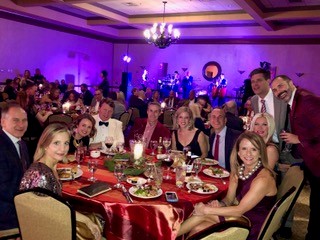 A hosted group celebrating together at their reserved round table inside a premium gala ballroom — the visual essence of a Party Inside the Party