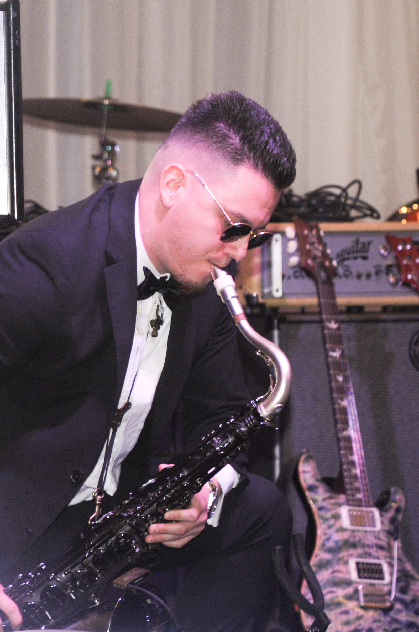 Saxophonist in tuxedo performing live